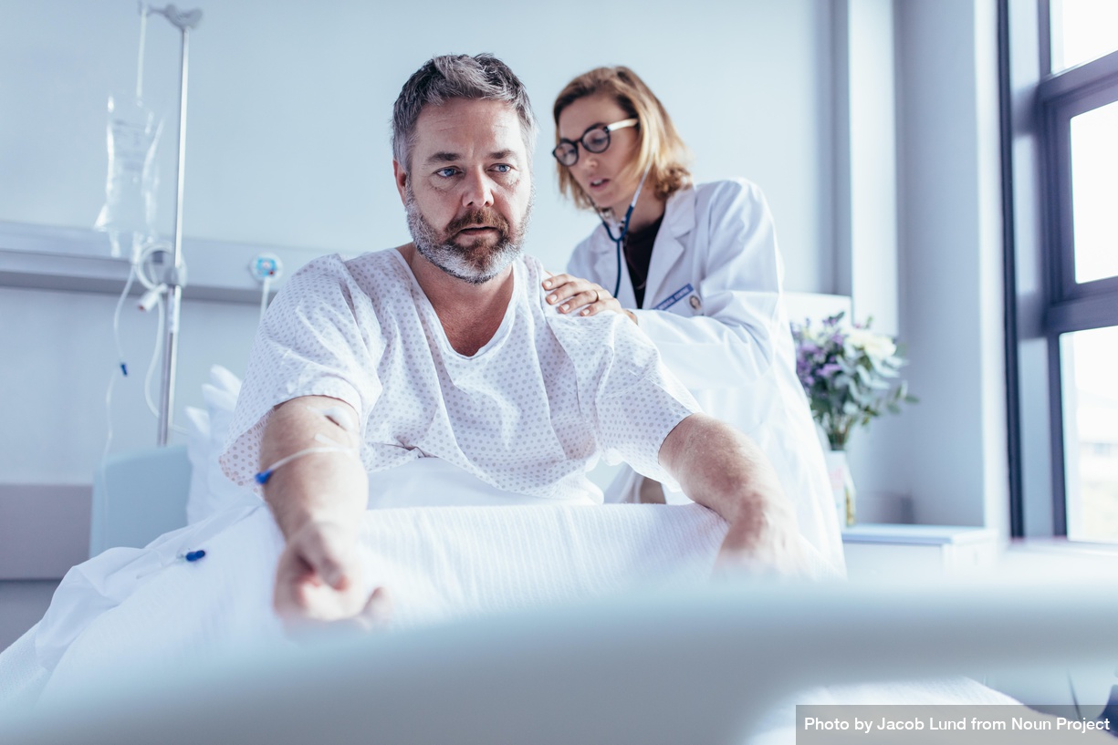 Np Doctor Examining Mature Man In Hospital Bed 42M9K5 Free